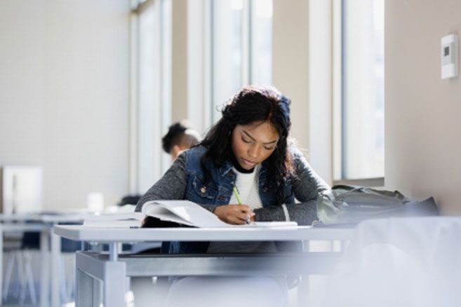 Female student writing working