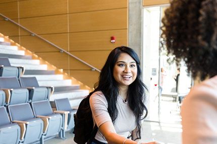 Female student happy smiling shaking hands teacher