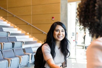 Female studnet happy smiling shaking hands teacher