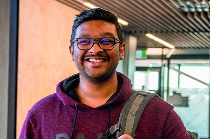 Male student portrait inside campus smiling