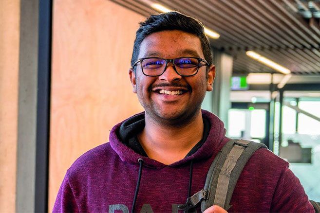 Male student portrait inside campus smiling