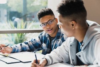 Male students classrom working studying together