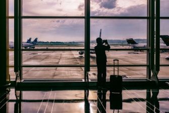 Person at airport taking photos