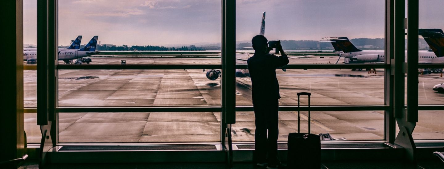 Person at airport taking photos