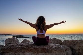 Person sitting outside meditating