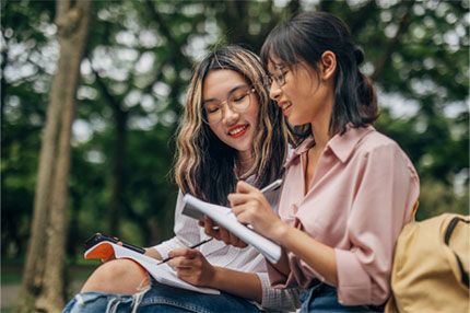Students happy studying together outside working