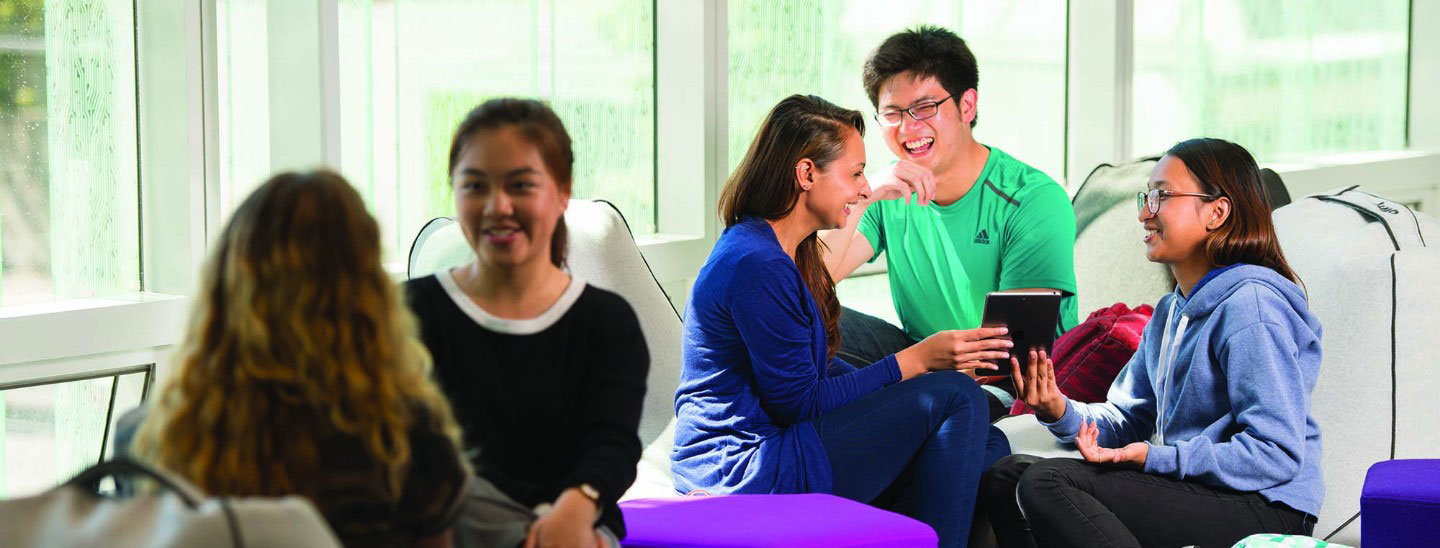 Students on campus socialising studying