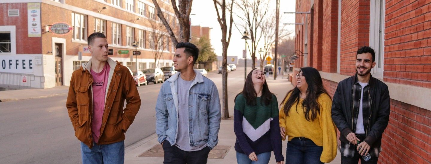 Students outside laughing talking