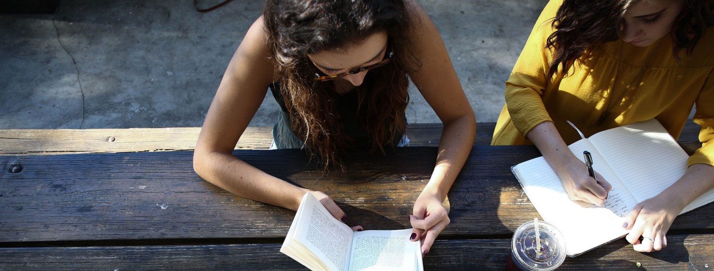 Students sitting outside table working together