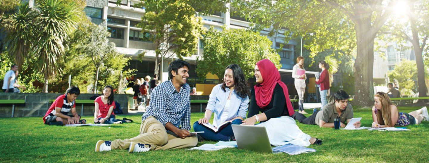 Students sitting outside talking studying